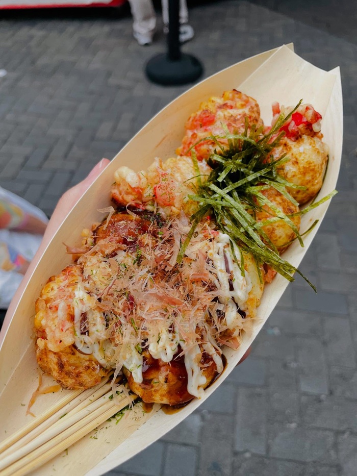 Thưởng thức takoyaki nóng hổi tại các gian hàng lễ hội Osaka. Nguồn: tegetegechichan